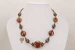 Rust red grey and black glass and bronze beaded necklace.