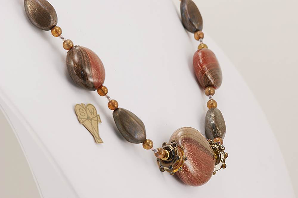 Rust red grey and black glass and bronze colored necklace.