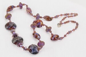 Raspberry and purple grape colored glass bead necklace with sterling silver accents.