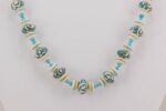 Turquoise and ivory colored glass and stone bead necklace.