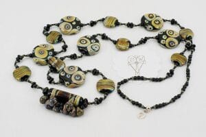 Black, brown and ivory color glass bead necklace.