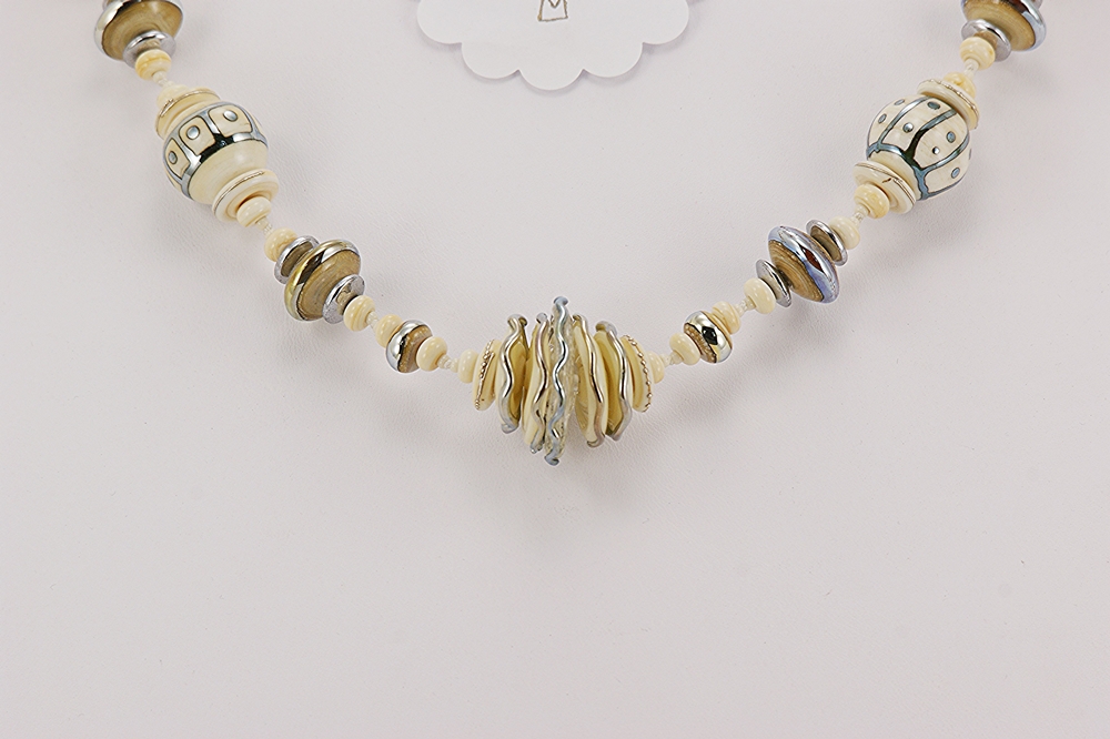 necklace made from ivory colored sterling silver highlighted glass beads