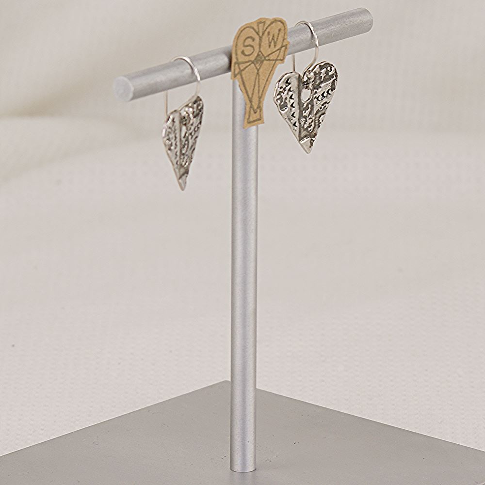 Handmade sterling silver heart earrings with artistic imprints.