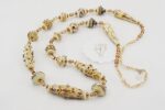 necklace with ivory colored silver accented beads and antique gold beads