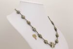 Handmade grey and ivory colored glass bead necklace with silver accents.