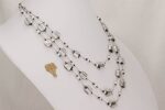 Triple strand necklace with sterling silver gilded, black and clear glass beads.