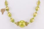 Unique necklace made of hand blown green and gold glass beads.