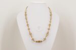 Necklace with ivory colored glass beads high lighted by sterling silver.