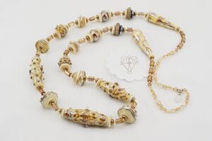 necklace with ivory colored silver accented beads and antique gold beads