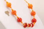 Bright orange glass bead necklace.