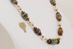 Handmade necklace with chestnut, ivory and teal colored glass beads.