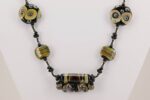Necklace with black and brown raku and ivory colored glass beads.