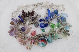 Semi precious stone and glass bead necklace with sterling silver chain.