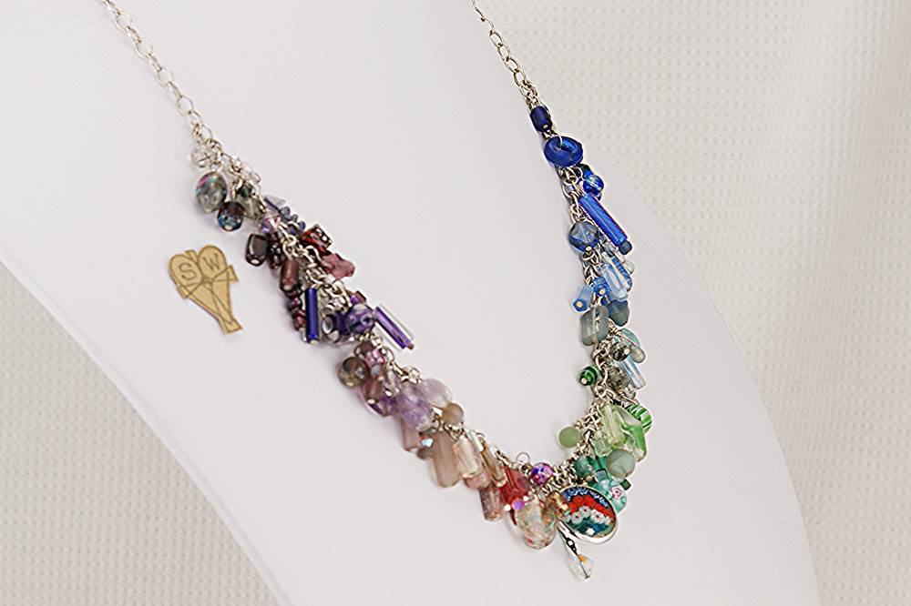 Multi color semi precious stone and glass bead necklace on sterling silver chain.