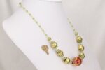 One of a kind necklace made of red and green blown glass beads with gold leaf finish.