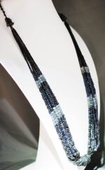 Tribal necklace made of black, gray and blue beads.