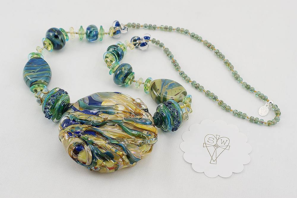 necklace with ocean hued colored glass in blues greens turquoise and soft beige