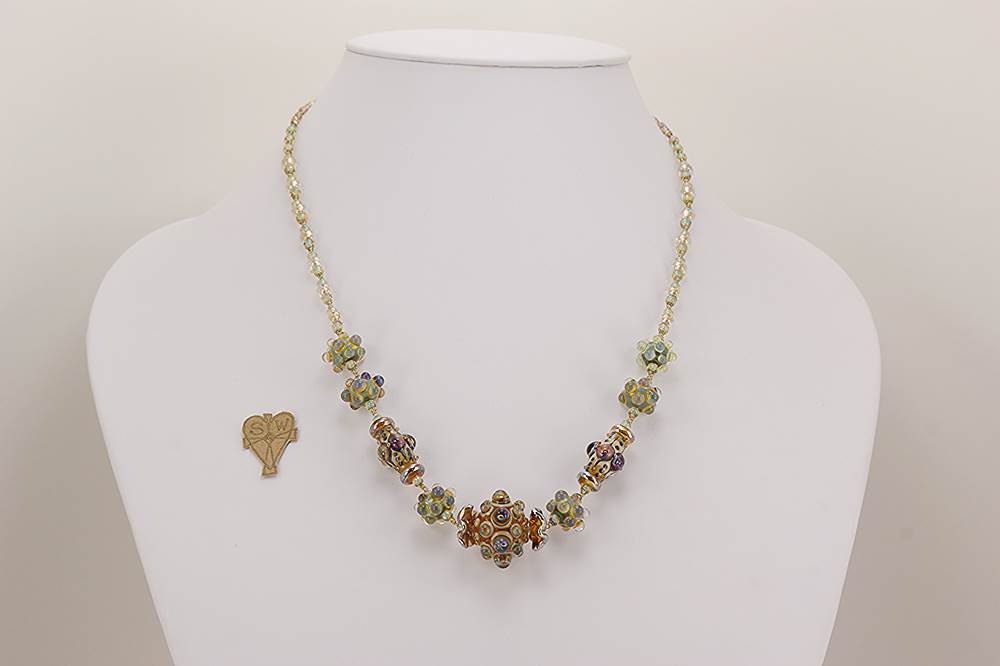 Brown, beige, seafoam green, sterling silver accented glass bead necklace.