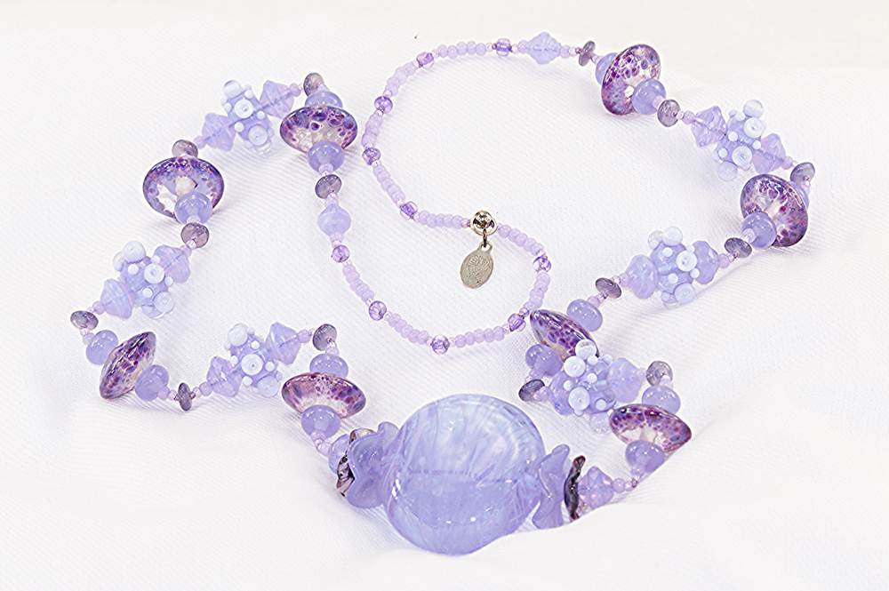 Heffalump and lavender colored glass bead necklace.
