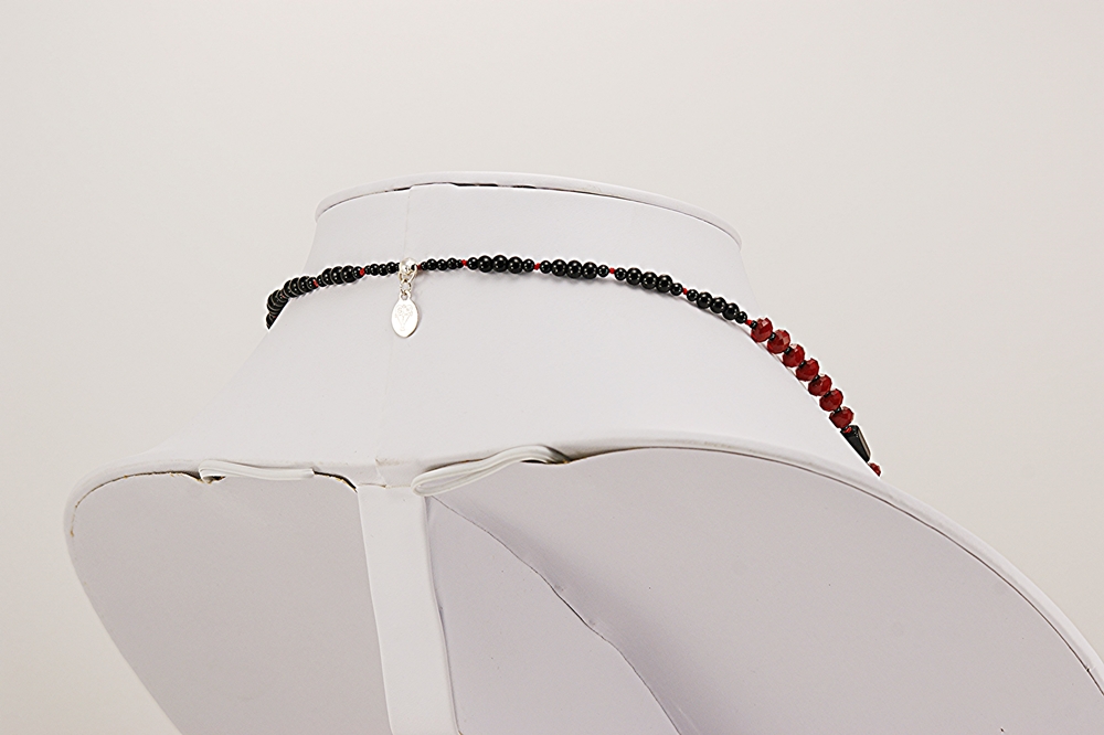necklace with red and black glass beads.