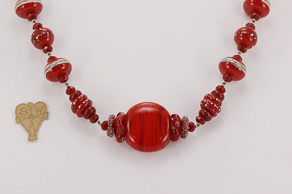 Handmade red glass bead necklace with sterling silver accents.
