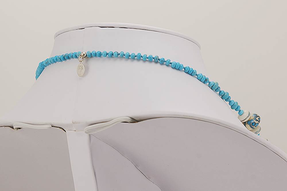 Turquoise and ivory colored glass beaded necklace.