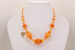 Bright orange handmade glass bead necklace.