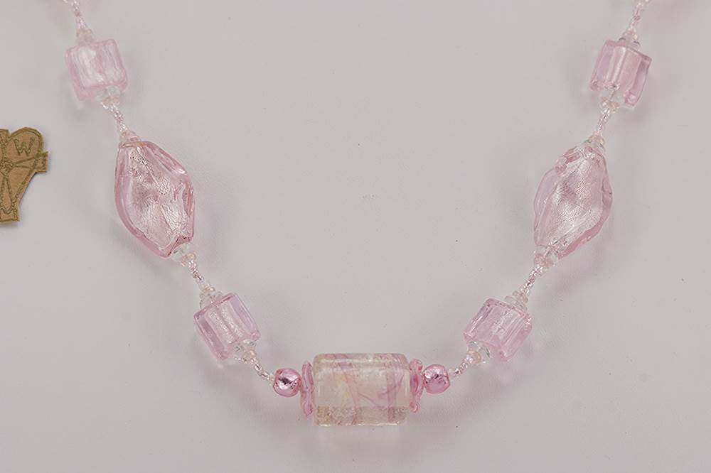 pink colored glass bead necklace with sterling silver lining.