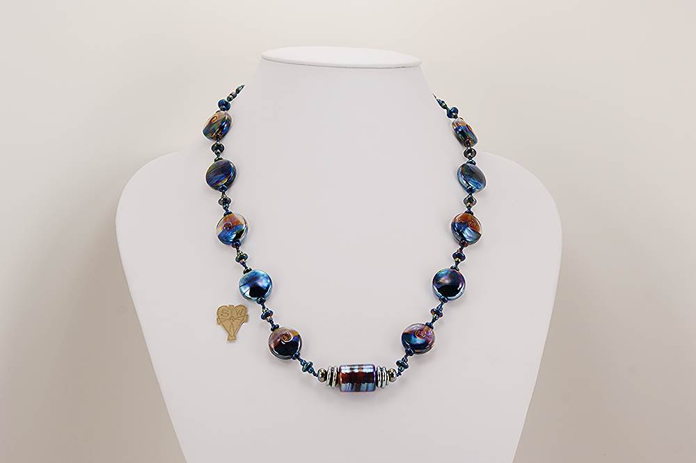 necklace with metallic blue and raspberry glass beads.