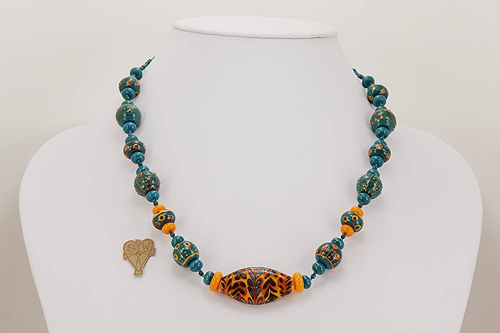 Orange and teal colored glass beaded necklace with silver accents.