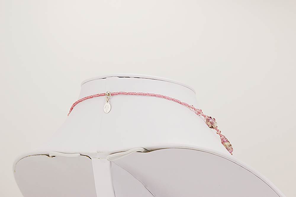 Deep pink glass bead necklace with quartz and silver highlights.