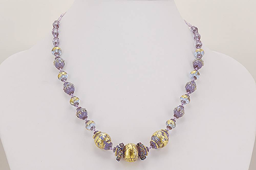 Lavender colored glass bead necklace with 22 karat gold and sterling silver accents.