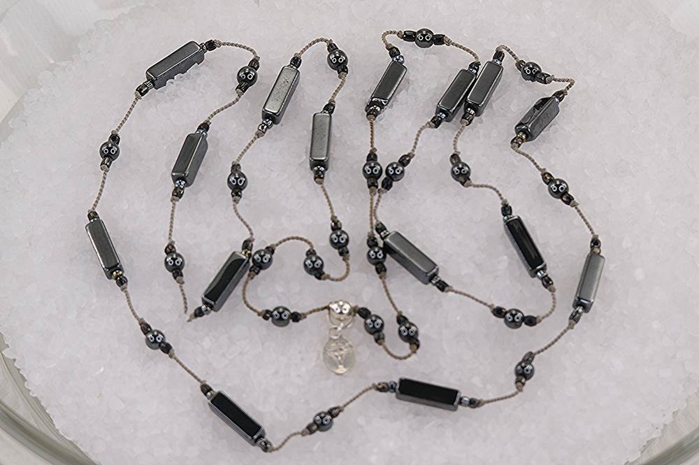 35 inch long, polished hematite necklace.