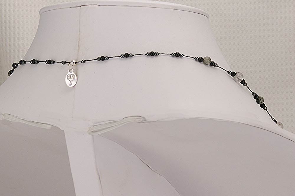 Smokey and clear rutilated quartz necklace with hematite and black spinel.