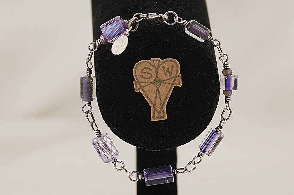 One of a kind, purple , glass bead bracelet, hand wrapped with sterling silver.