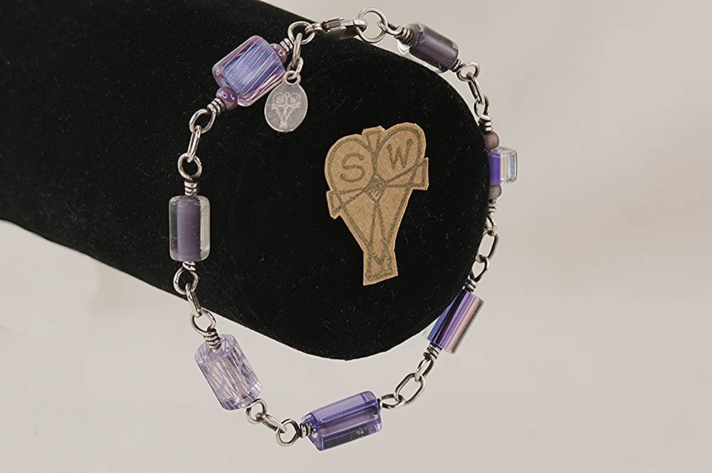 Hand blown, lavender glass bead bracelet wrapped with sterling silver wire.