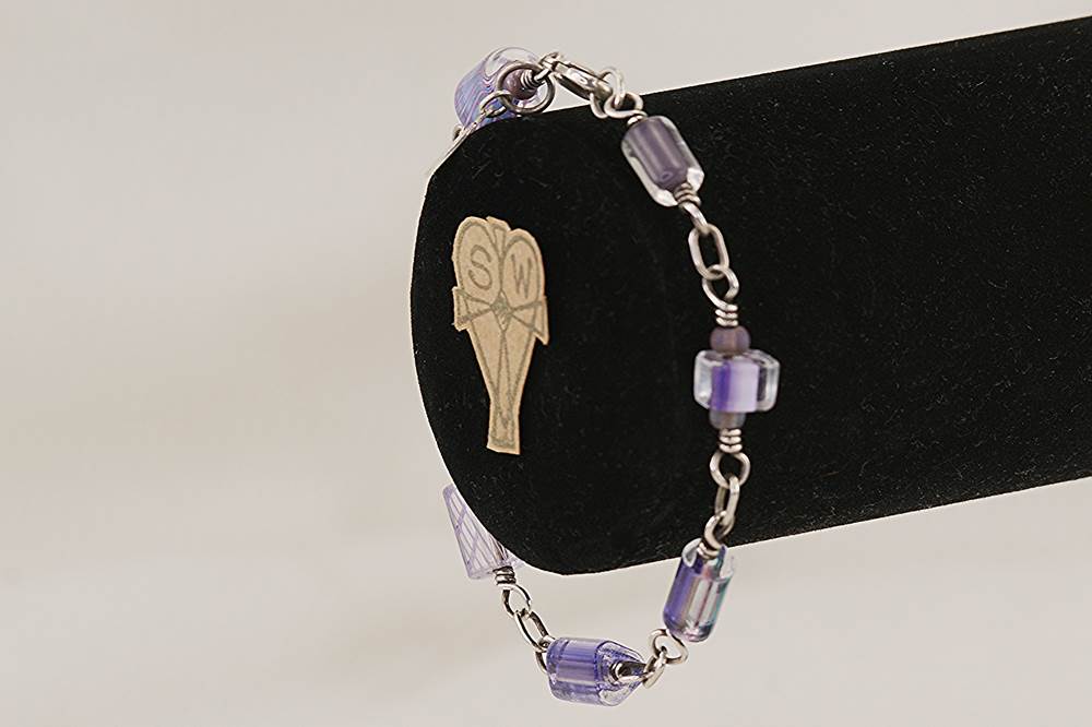Purple glass bead bracelet with sterling silver.