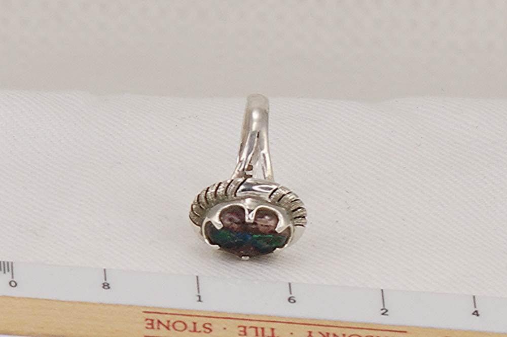 Silver and boulder opal ring with ruler.