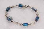 Handmade ocean blue bead bracelet with sterling silver chain and clasp.