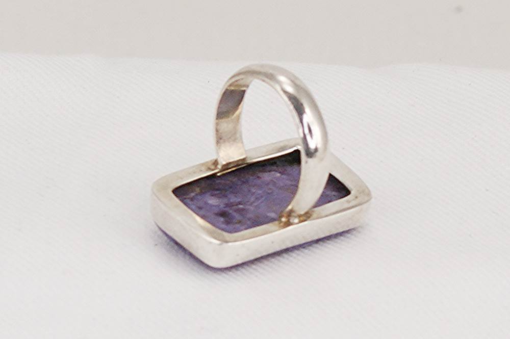 Sterling silver ring with rectangular, purple, charoite crystal.