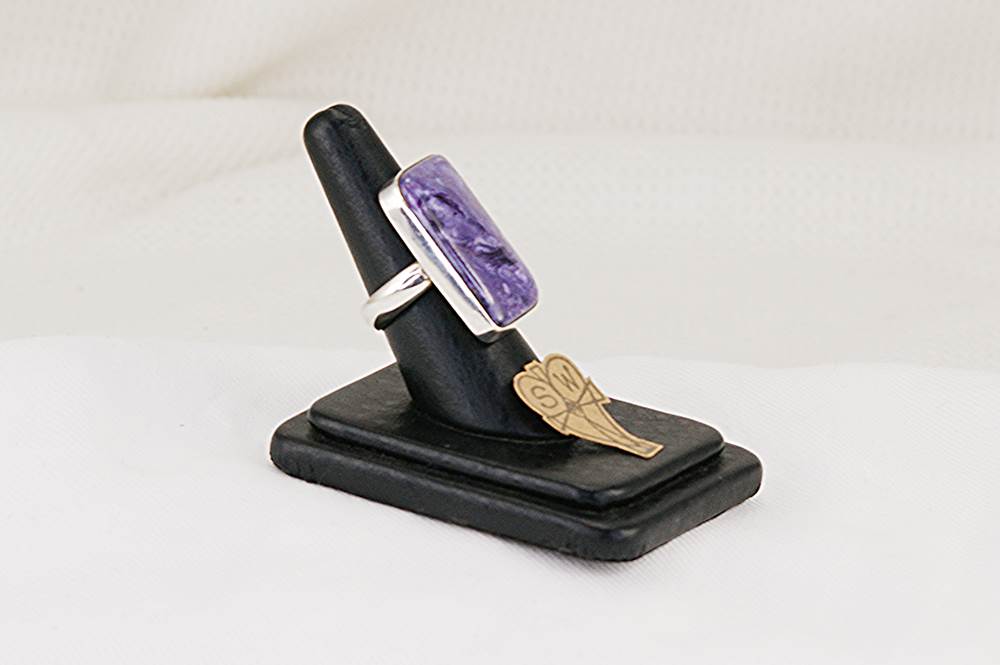 Sterling silver ring with rectangular charoite stone.