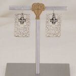 Handmade sterling silver scroll and cross earrings.