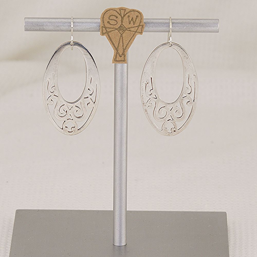 Handmade sterling silver scroll cut earrings.