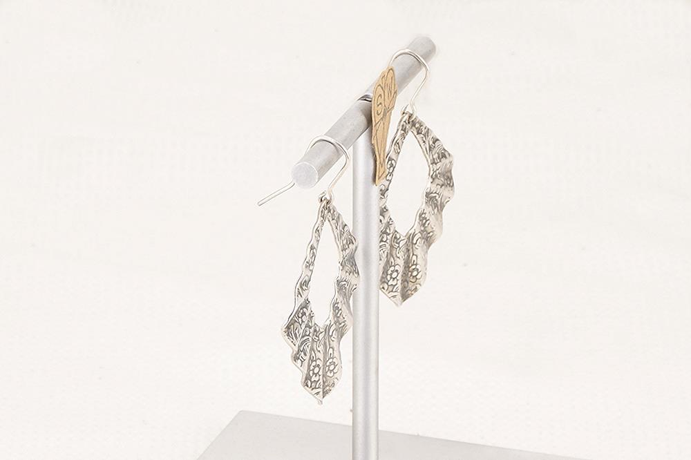 Pleated sterling silver floral earrings.