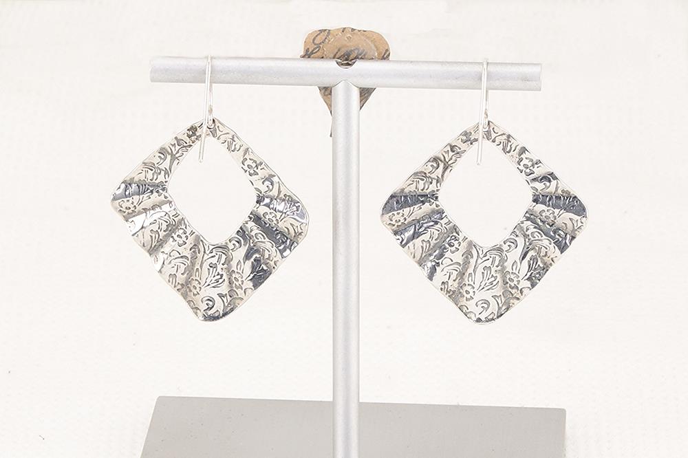Pleated silver floral earrings.