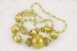One of a kind, green and gold blown glass bead necklace.
