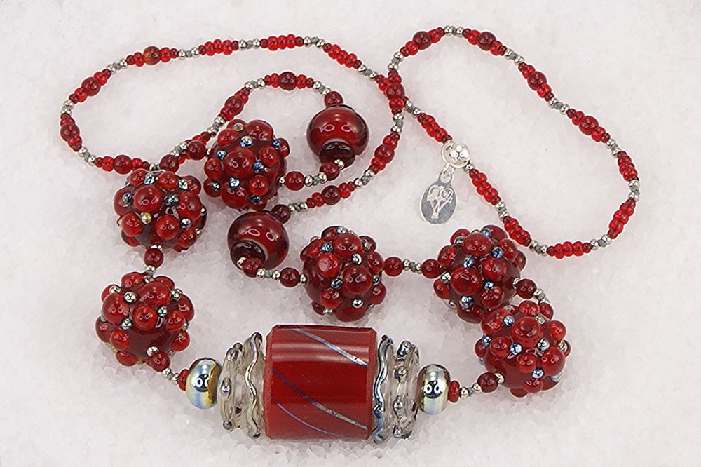 One of a kind red and sterling silver glass bead necklace.